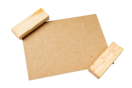 Top view of empty blank brown card with wooden blocks on white background. Mockup, copy space. Greeting or invitation card with flat lay styleの写真素材