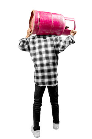 Man is carrying a pink gas cylinder on his shoulder isolated over a white background. The man is wearing a plaid shirt and black pantsの写真素材