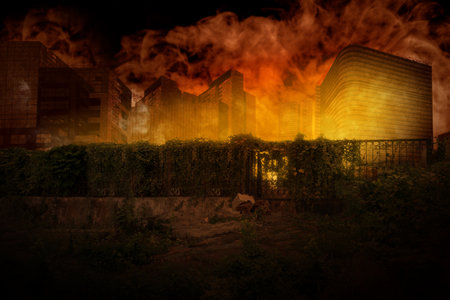 Destruction city with fires explosion with dramatic sky background. Fire is orange and yellow, and...