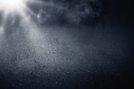 Surface of black concrete floor. Abstract texture with mist or fog. Mockup or template. Copy space. Dark backgroundの写真素材