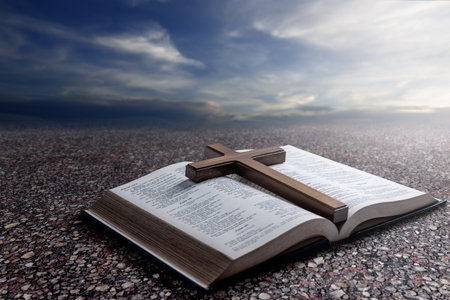 Religion cross and opened book of Holy Bible. Symbol of faith and worship in God. Religious christian service, holiday or conceptの写真素材