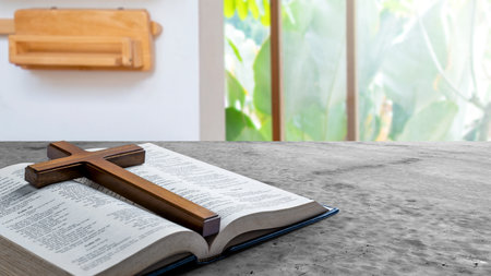 Religion cross and opened book of Holy Bible. Symbol of faith and worship in God. Religious christian service, holiday or conceptの写真素材