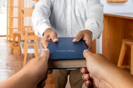 Man giving a holy bible to other. Symbol of faith and worship in God. People christianity prayer....