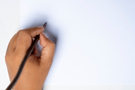 Human hand writing using calligraphy reeds on white paper. Mockup. Copy space. Reeds pen ink for writing Arabic calligraphyの写真素材