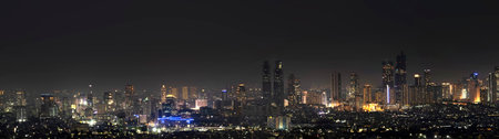 Panorama view of modern building skyscrapers and futuristic architecture with night scene. Jakarta, Indonesia. Cityscapes backgroundの写真素材