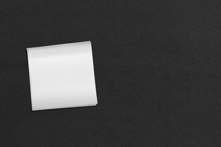 Top view of white note paper with black background. Mockup. Copy space. Presentation or template....