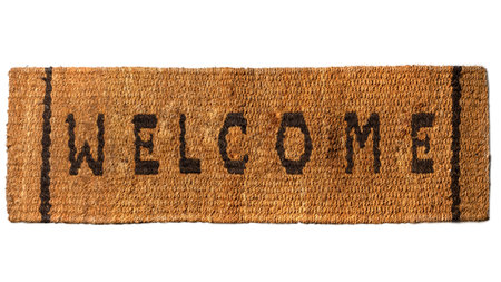 Top view of brown doormat with welcome text on it isolated over white background. Welcome greetings sign. Flat layの写真素材