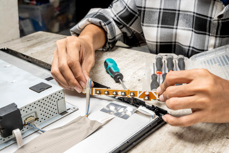 Man technician repairing television. Service, maintenance or repairing conceptの写真素材