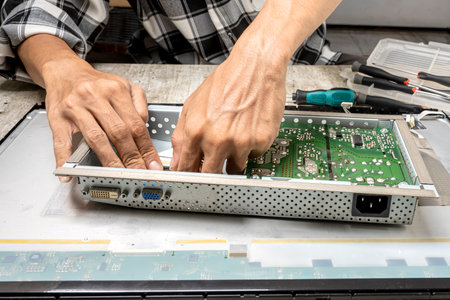 Man technician plug the television socket. Service, maintenance or repairing conceptの写真素材