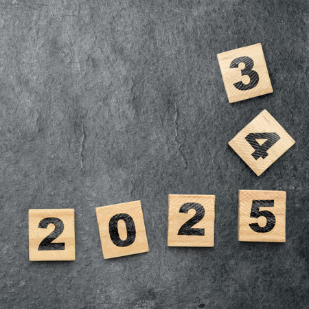 Wooden blocks with number 2025 on black background. Happy New Year concept or New Year Celebrationの写真素材