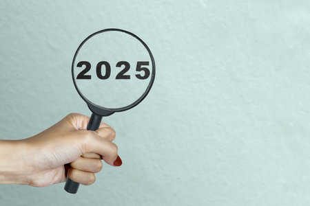Top view of 2025 number written on the wall look through magnifying glass. Happy New Year concept or celebrationの写真素材