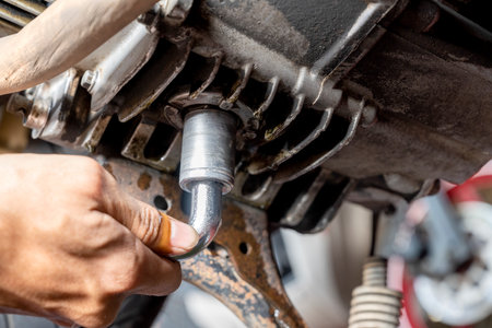 Motorcycle mechanic repairing the motorcycle at garage. Motorcycle repair, maintenance and service conceptの写真素材