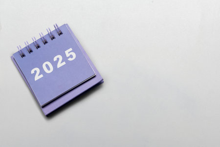 Calendar or Notepad with the number 2025 on a white background. Copy space. Mockup. Happy New Year concept or Celebrationの写真素材