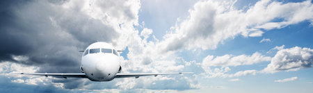 Commercial airplane flying in the sky with cloudscapes background. Travel by airplane concept