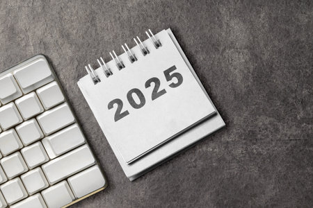 Calendar or Notepad with the number 2025 on a black background. Happy New Year concept or Celebrationの写真素材
