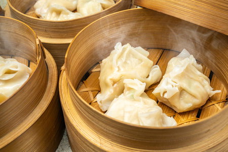 Assorted chinese dim sum dumpling on bamboo wooden basket bowl on wooden table. Food for breakfast, lunch or dinner. Chinese Or Lunar New Year decorationの写真素材