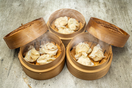 Assorted chinese dim sum dumpling on bamboo wooden basket bowl on wooden table. Food for breakfast, lunch or dinner. Chinese Or Lunar New Year decorationの写真素材