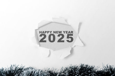 Top view of ripped paper with the text of Happy New Year 2025 written on a white background. Happy New Year concept or Celebrationの写真素材