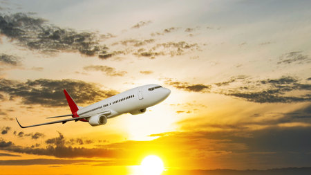 Commercial airplane flying in the sky with cloudscapes in the sunset scene background. Travel by airplane conceptの写真素材