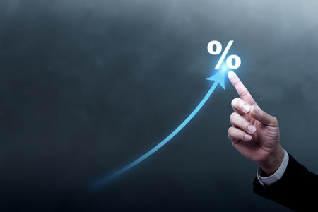 Business hand shows an arrow pointing up with a percentage symbol. Concept of interest rate, business growth, sales, mortgage, or taxesの写真素材