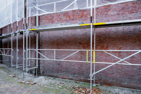 Building site with red brick wall background. Construction conceptの写真素材