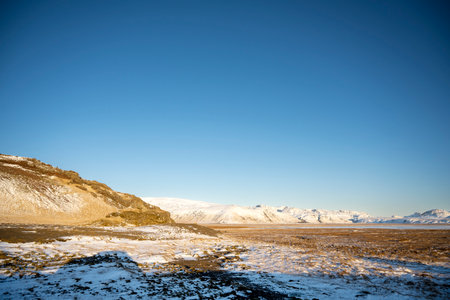 Panoramic view of snow capped mountain landscapes with blue sky background in Iceland. Nature, travel, winter background or wallpaperの写真素材