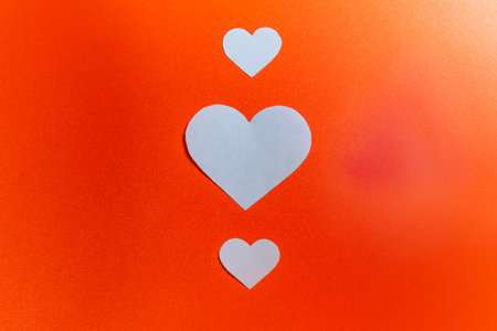 White heart on a colored background. Copy space. Mockup. Valentine Card. Decoration for Valentine celebrationの写真素材