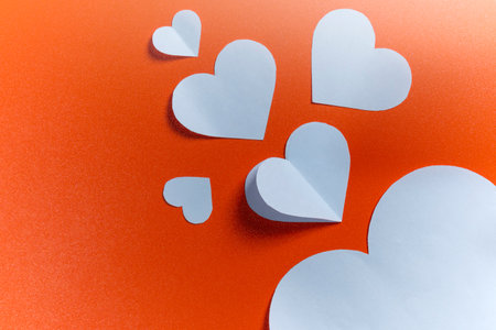 White heart on a colored background. Copy space. Mockup. Valentine Card. Decoration for Valentine celebrationの写真素材