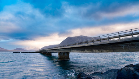 Panoramic view of the bridge over the sea with mountain range landscapes on KolgrafarfjÃ¶rÃ°ur or Kolgrafavegur, Iceland. Nature, travel, winter background, or wallpaperの写真素材