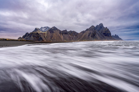 Panoramic view of Vestrahorn mountain with black sand beach and coastline on Stokksnes, Iceland. Nature, travel, winter background, or wallpaperの写真素材