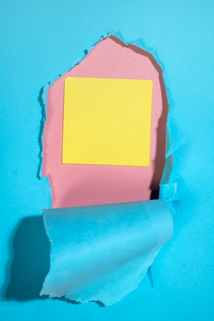 Empty notepaper on the hole of ripped paper. Mockup or Copy space. Template. Presentation or advertising. Concept of message or communicationの写真素材