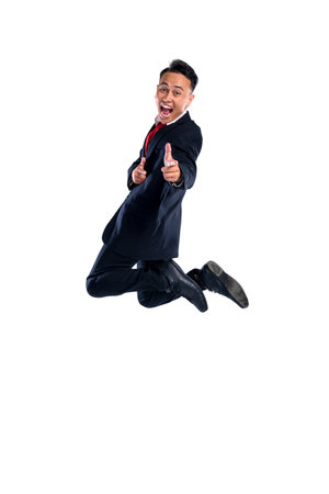 Portrait of an Asian businessman jump with a pointing hand gesture isolated over a white background. Concept of business, entrepreneur, and successfulの写真素材