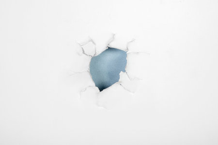 Top view of the hole from ripped white paper with a colored background. Mockup. Copy space. Presentation or template. Flat layの写真素材