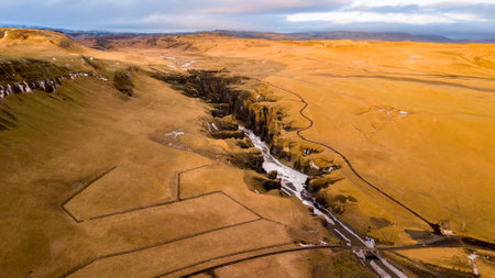 Aerial landscape view of Fjarrgljfur or Fjadrargljufur Canyon with Fjadrar river flow on Iceland. Taken by drone. Nature, travel, winter background, or wallpaperの写真素材