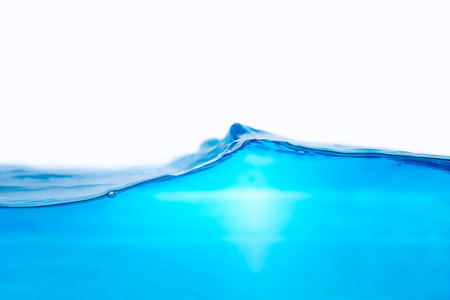 Closeup view of dynamic flowing blue water waves on white background. Liquid splash. Texture and abstract backgroundの写真素材
