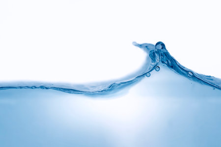 Closeup view of dynamic flowing blue water waves on white background. Liquid splash. Texture and abstract backgroundの写真素材