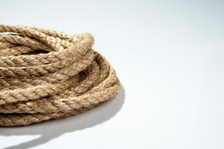 Closeup view of coiled ropes string isolated over a white backgroundの写真素材