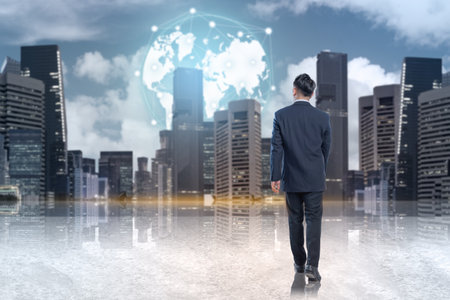 Businessman walking to globe with a connected network in modern city background. Concept of global business development and digital marketing strategyの写真素材