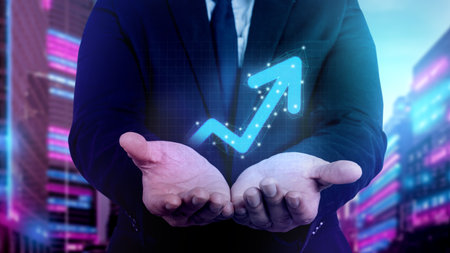 Businessman showing a holographic upward arrow of economic chart and global economic trend. Concept...
