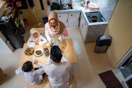 Asian Muslim wife preparing food for her family. Concept of Eid Al Fitr, Idul Fitri, and Ramadan Mubarak celebrationの写真素材