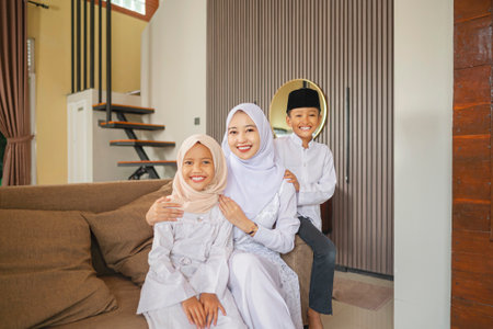 Portrait of the Indonesian Muslim mother with her child celebrating Eid Mubarak. Concept of Happy Lebaran, Eid Al Fitr, Idul Fitri, and Ramadan Mubarak celebrationの写真素材