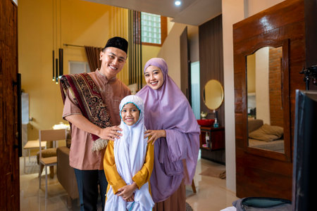 Portrait of the Indonesian Muslim family after Eid al-Fitr salat inside the house. Concept of Happy Lebaran, Eid Al Fitr, Idul Fitri, and Ramadan Mubarak celebrationの写真素材