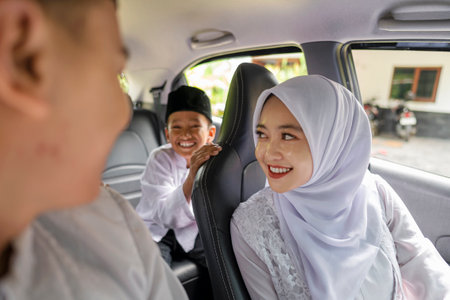 An Indonesian Muslim family is going mudik or traveling to their hometown by car. Concept of Happy Lebaran, Eid Al Fitr, Idul Fitri, and Ramadan Mubarak celebrationの写真素材
