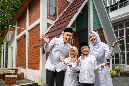 An Indonesian Muslim family arrives in their hometown. Mudik or traveling to their hometown. Concept of Happy Lebaran, Eid Al Fitr, Idul Fitri, and Ramadan Mubarak celebrationの写真素材