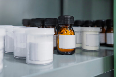 Shelf storage facility stocked with products of organized pill bottles in a modern sterile medicine factory environmentの写真素材