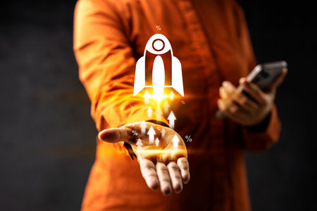 Business person with mobile phone showing virtual rocket icon. Data management system. Smart corporate and technology innovation on a virtual screen. Concept of business, finance, and global networkの写真素材