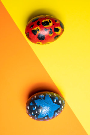 Top view of a colorful decorated easter eggs on a colored background. Concept of celebrating the easter holidayの写真素材
