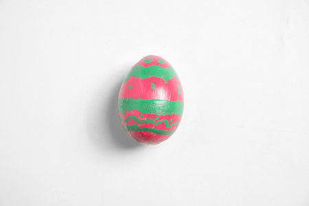 Top view of a colorful decorated easter egg isolated over a white background. Concept of celebrating the easter holidayの写真素材