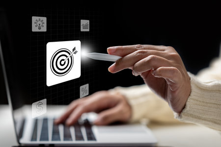 Business person with a laptop touching virtual target goal icons. Data management system. Smart corporate and technology innovation on virtual screen. Concept of business, finance, and global networkの写真素材