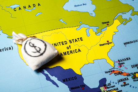Map of the USA or the United States of America with a money bag of dollars. Concept of the United States of America versus China trade war disputes or economic conflictの写真素材